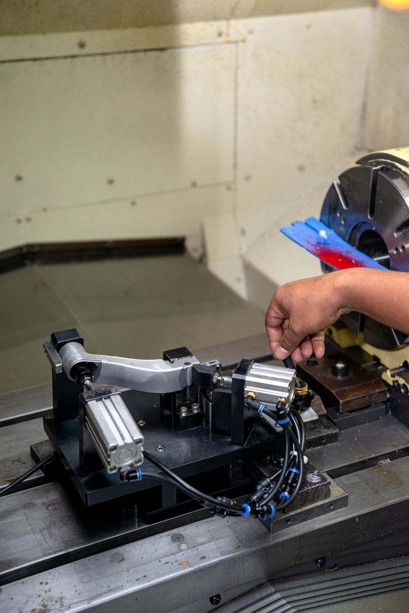Machining setup with operator loading a part into a precision fixture